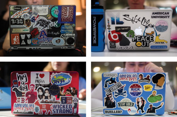 four laptops featuring an array of colorful stickers