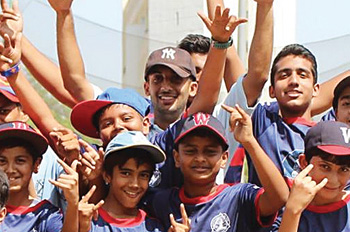 Indian children cheer on the baseball field