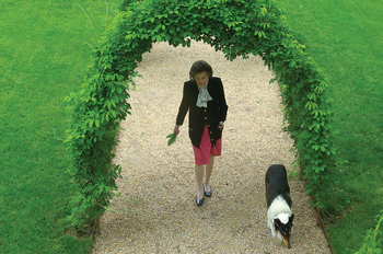 Donor Mary Weinmann walks her dog in her garden