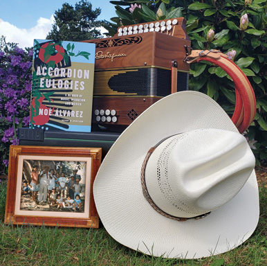 an accordion, cowboy hat, old family photo and a copy of Alvarez's book