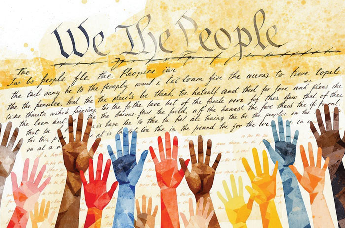 Hands raised before the Constitution, which says 