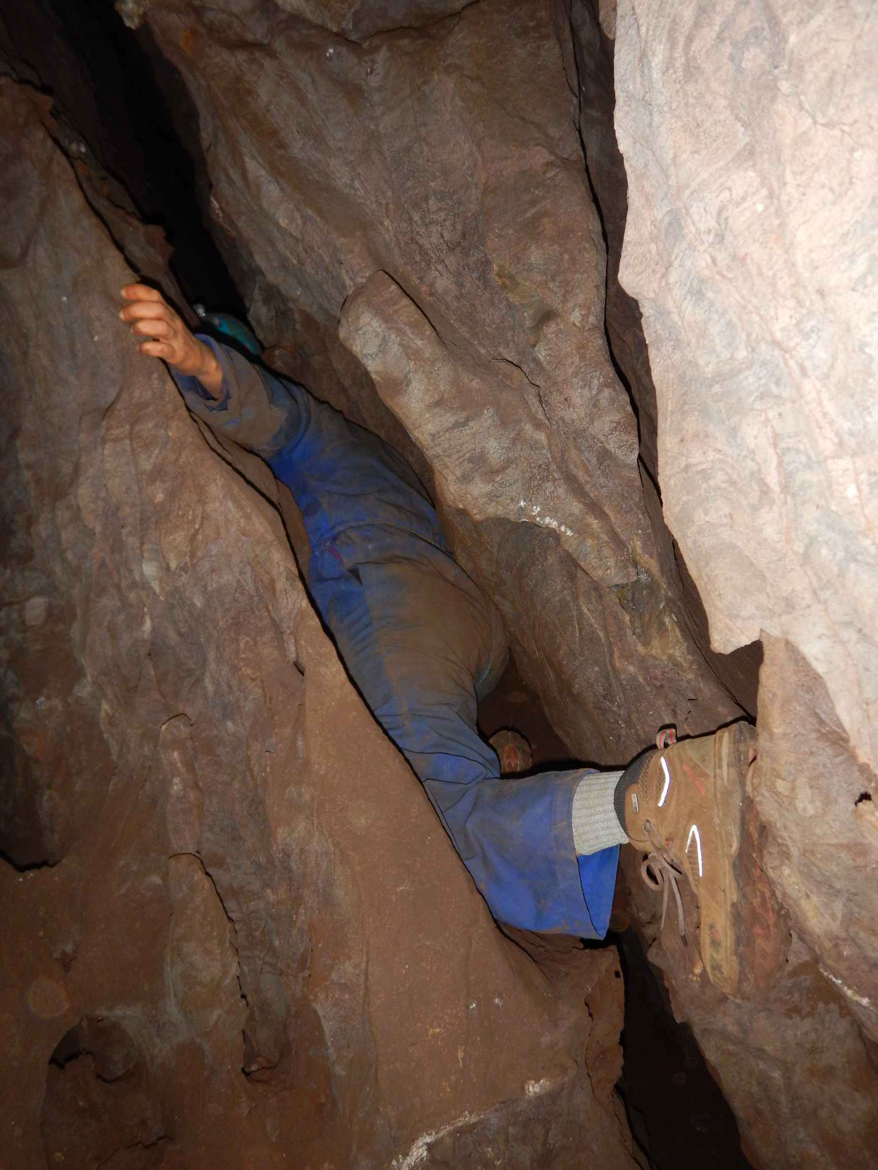 Peixotto navigating a tight passage in the cave.