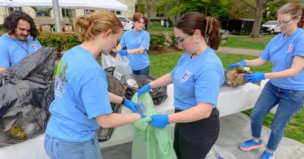 AU students sort through trash in front of Mary Graydon Center. Photo by Jeff Watts.