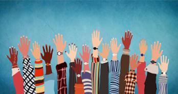 people of different races raising their hands