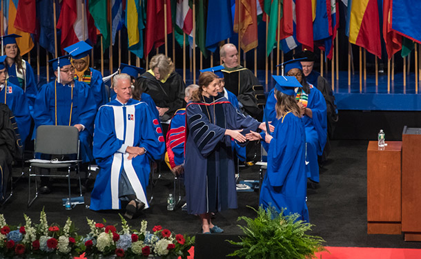President Burwell shakes graduates hand