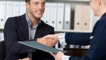 Graduate student shaking hands with employer