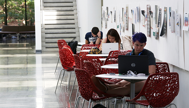 Students Studying at desks in hallway of Katzen Arts Building at American University