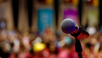 American University Events: Blurred background of attendees with microphone up close