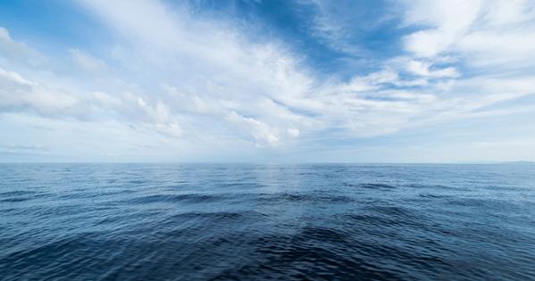 A clear blue sky over ocean waves