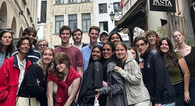 A group of smiling Global Scholars stand in a street in Spain.