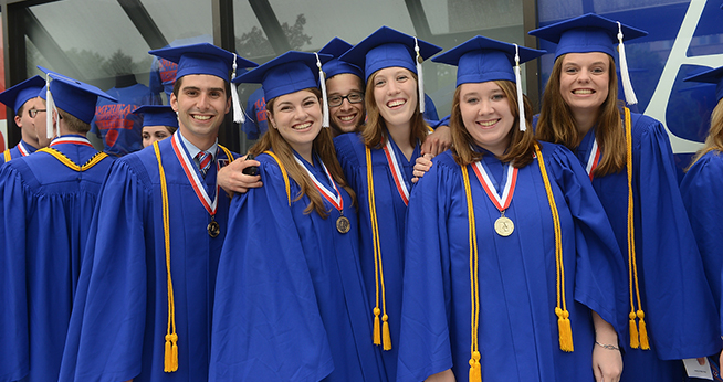 group of SIS honors graduate students in their commencement regalia