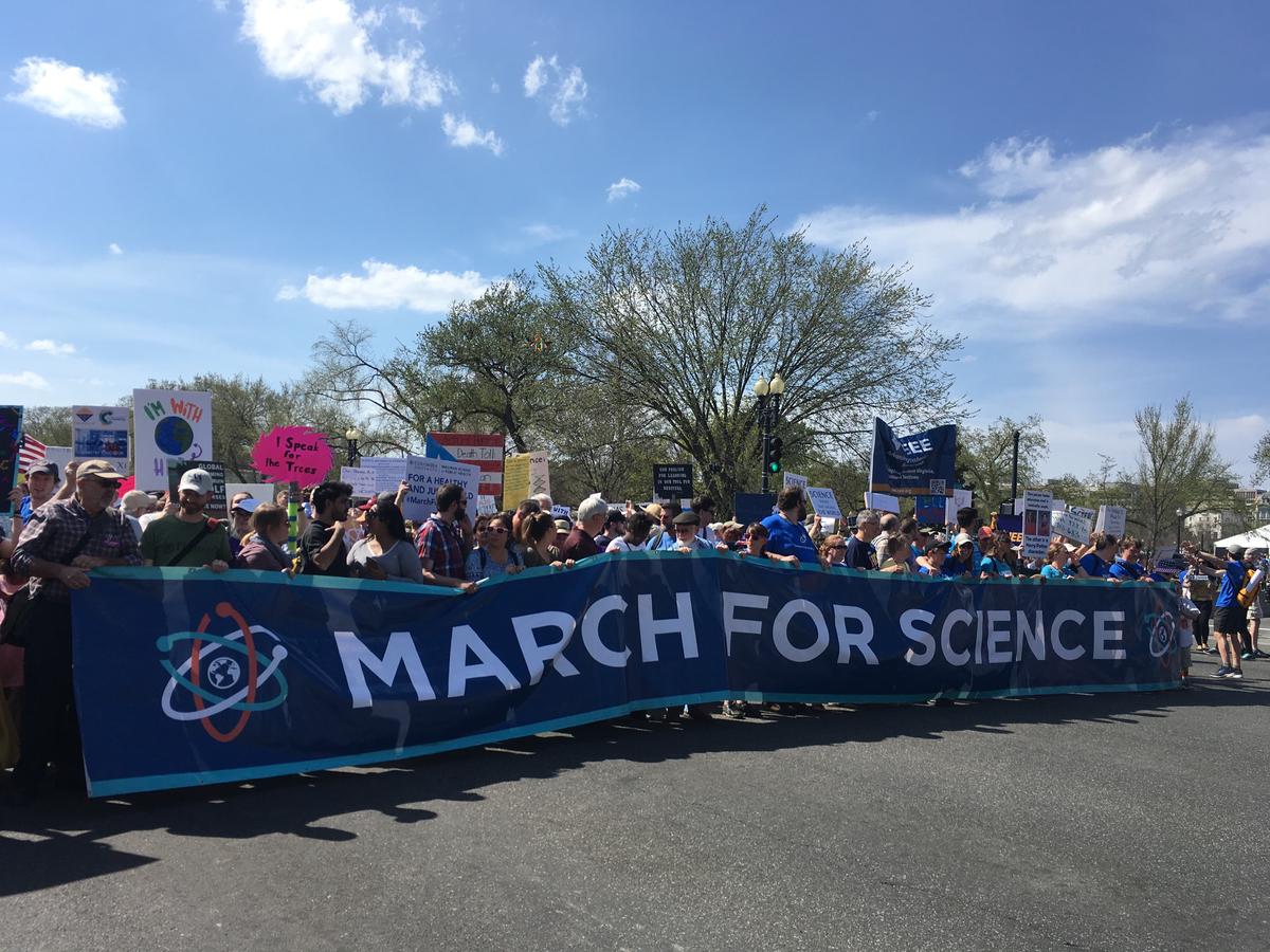 Crowd gathers holding March for Science sign
