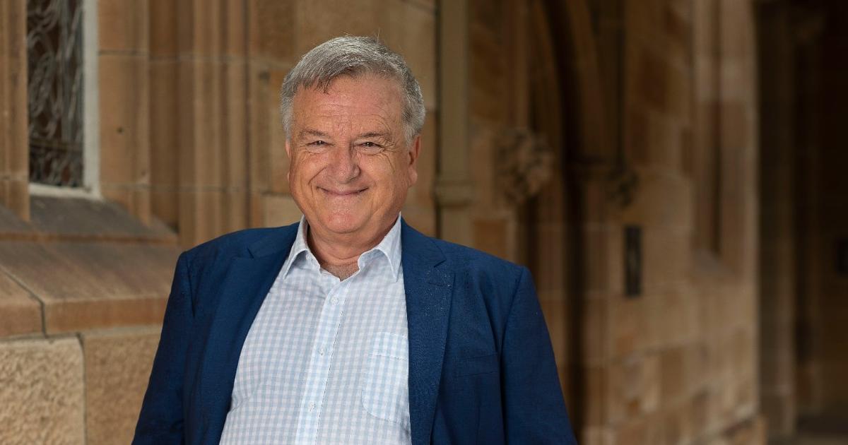 Ken Cruickshank standing in front of stone background