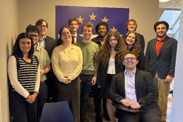 students standing in front of EU flag