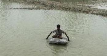 Person paddling through flooded area