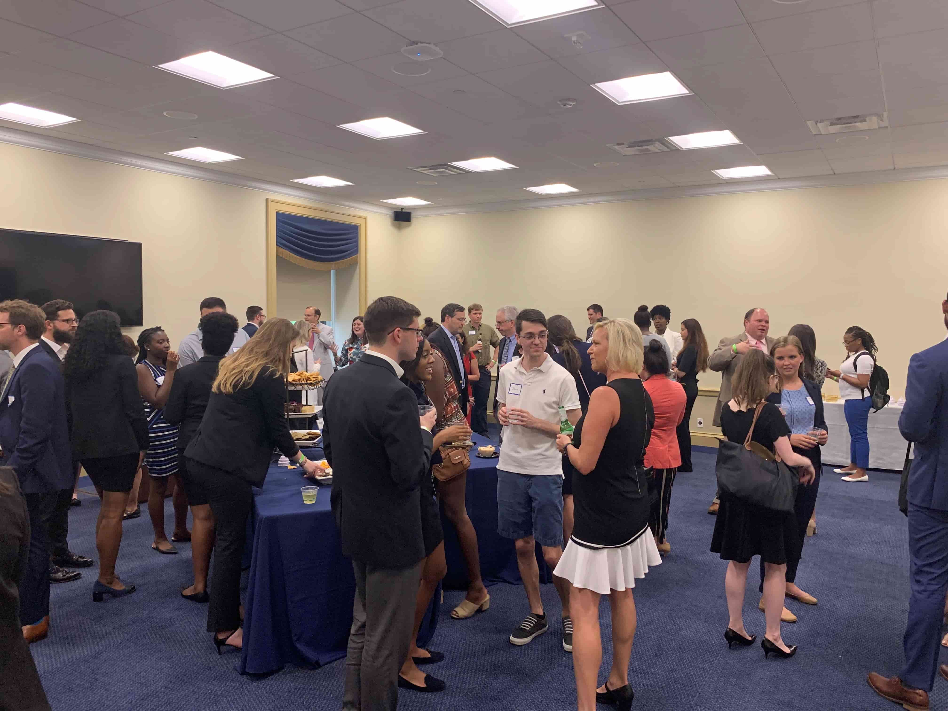 Attendees of the Happy Hour on the Hill event mingle with snacks and drinks