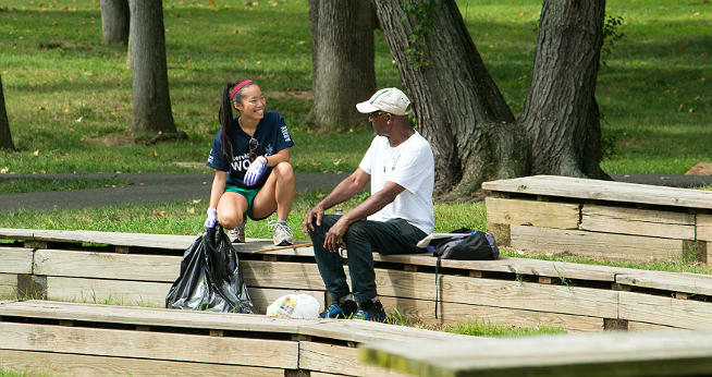 Student and staff member talking in the ampitheater