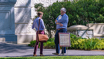 A faculty member and student engage in conversation