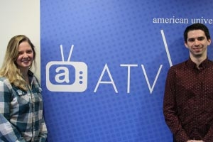 Abi Weaver (left) and Ben Fall (right pose in front of the ATV sign near ATV studios.