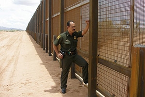 U.S. Customs and Border Protection officer stands at the Arizona section of the American border with Mexico.