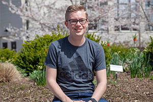 Freshman Harrison Eichelberger standing near the Cherry Blossoms.