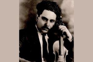 Man in jacket and tie holding a violin