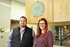 Chris Moody and Megan Litke posing at the ceremony recognizing Cassell Hall's LEED-silver certification. 