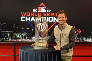 Graham P. Wheeler standing next to a table with a large trophy on it