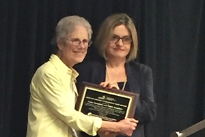 Laura Langbein accepts the JCPA and ICPA-Forum's Best Comparative Paper Award.