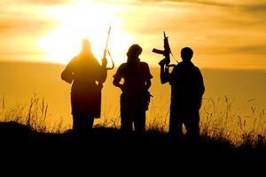 Silhouette of three foreign fighters