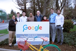 Students stand next to a Google sign.