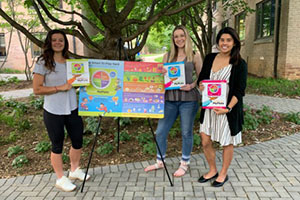 Three students with the Eat Smart banner