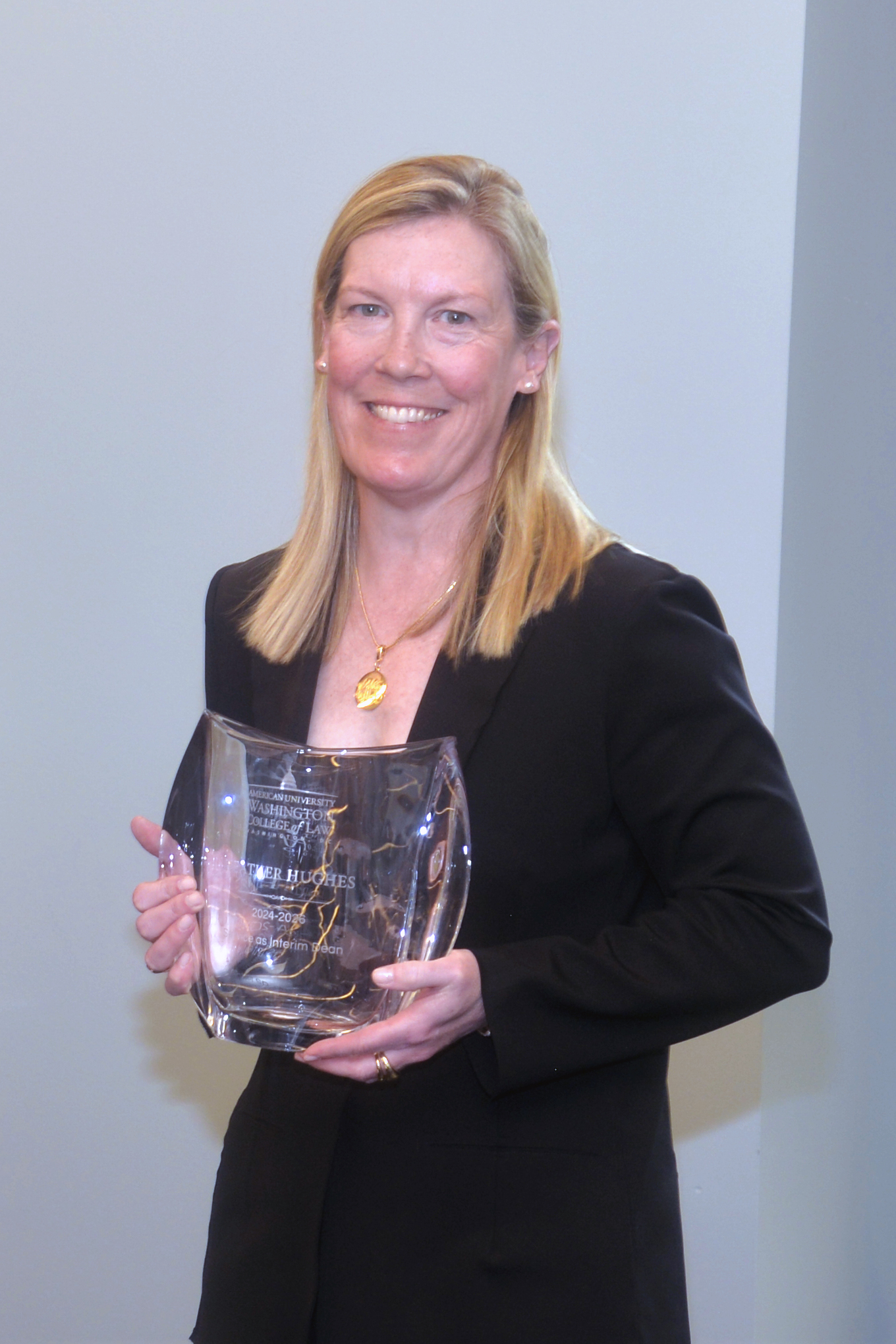 Interim Dean Heather Hughes with her service recognition award. Interim Dean Heather Hughes with her service recognition award.