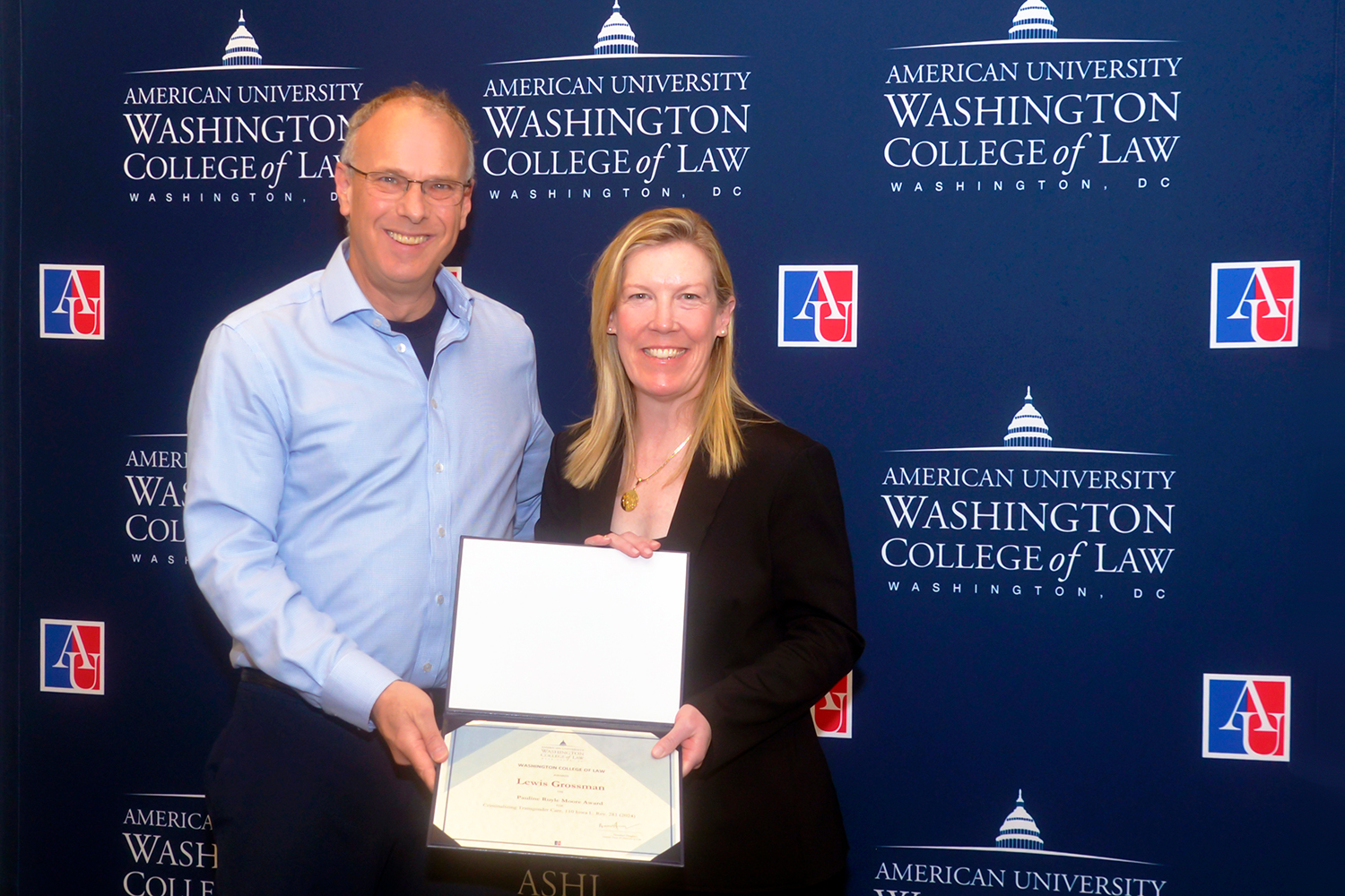 Professor Lewis Grossman receives the Pauline Ruyle Moore Award from Interim Dean Heather Hughes. Professor Lewis Grossman receives the Pauline Ruyle Moore Award from Interim Dean Heather Hughes.